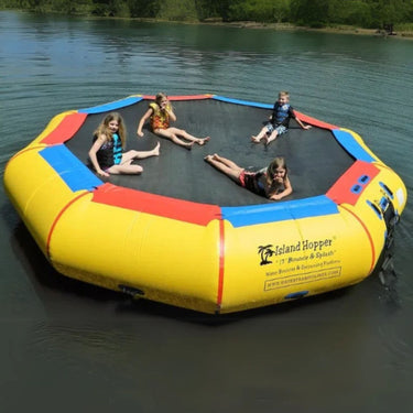 Island Hopper 17 Bounce n Splash Water Bouncer Floating In Calm Water With Four Kids Resting